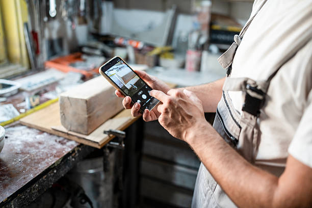 Tradesperson photographing a job with a phone